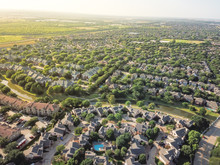 Top View Urban Sprawl In Dallas-Fort Worth Area. Apartment Building Complex And Suburban Tightly Packed Homes Neighborhood With Driveways Flyover. Vast Suburbia Subdivision In Irving, Texas, US