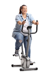 Canvas Print - Overweight woman exercising on a stationary bike