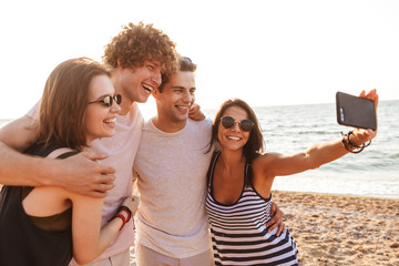 Wall Mural - Happy friends loving couples make selfie by mobile phone.