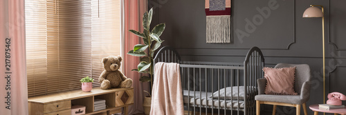 pink and gray nursery with dark furniture