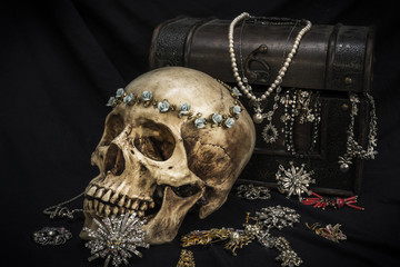 Still life with a human skull with old treasure chest and gold, diamond