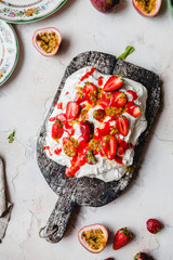 Wall Mural - top view of tasty strawberry and passion fruit meringue cake on wooden table