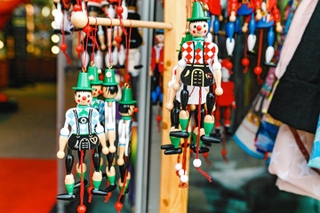 wooden dolls, toys and puppets for sale at souvenir market in Germany