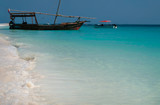 Fototapeta Na sufit - A wooden pirate ship by the shore. The coast of the Indian Ocean. Zanzibar of Tanzania