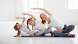 © JenkoAtaman - children practicing engaged in gymnastics and yoga with  teacher.