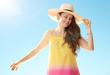 © Alliance - relaxed healthy woman in colourful dress against blue sky