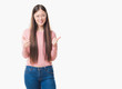 © Krakenimages.com - Young Chinese woman over isolated background wearing glasses success sign doing positive gesture with hand, thumbs up smiling and happy. Looking at the camera with cheerful expression, winner gesture.