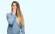 © Krakenimages.com - Beautiful young woman wearing sweater and jeans cover mouth with hand shocked with shame for mistake, expression of fear, scared in silence, secret concept