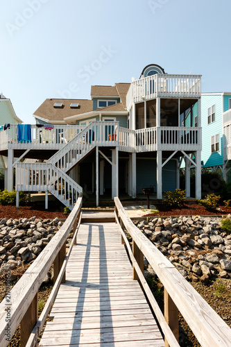 Long Wooden Dock Leading To A Luxury Vacation Rental Beach House