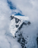 Fototapeta Na ścianę - Clouds try to hide the glaciated peaks of the Annapurnas