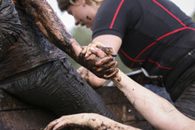 Close Up On Three People During Mud Race