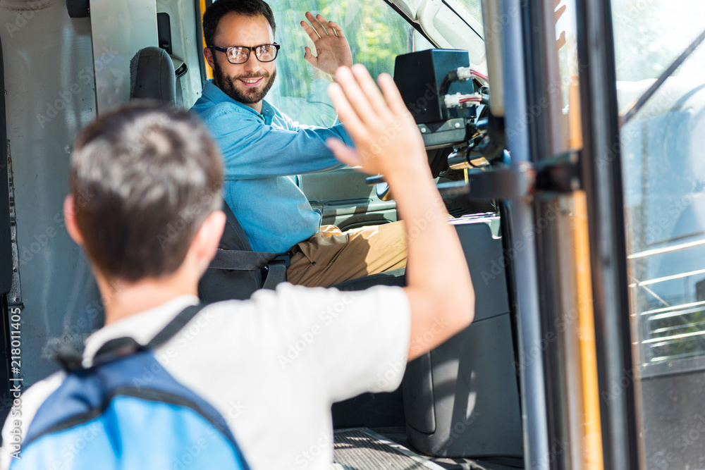 handsome smiling bus driver greeting schoolboy who entering bus Stock ...