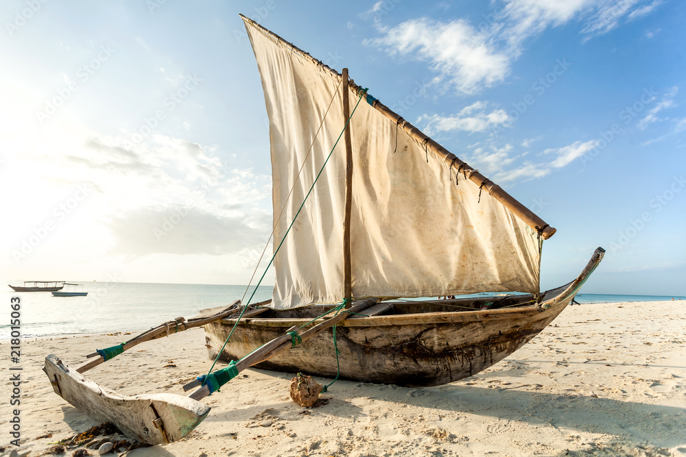 A Dhow boat on the beach. Sailing boat on the shore. - obrazy, fototapety, plakaty 