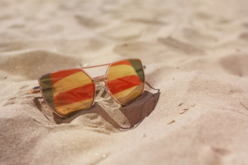 Sunglasses on the sand in summer