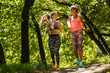 © BalanceFormCreative - Two young female friends jogging at the woods.Laughing and making fun.