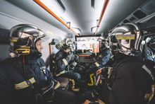 Firemen Working Inside An Emergency Vehicle.