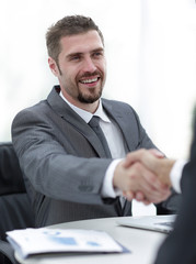 Wall Mural - closeup .handshake of business partners above the Desk