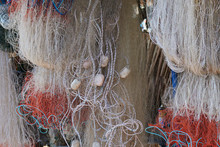 Fishing Nets Hang Outdoor, Drying In The Sun. Vintage Fishing Nets For Design About A Marine Life Or Craft Of Fishermen In Retro Style.  Fishing Equipment And Old Tackle As Texture.