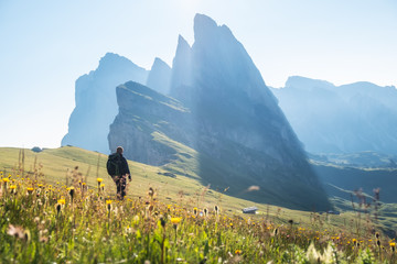 Wall Mural - tourist on the high rocks background. sport and active life concept. adventure and travel in the mou