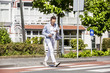 © Westend61 - Man crossing a street