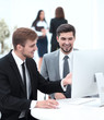 © ASDF - employees are talking sitting behind a Desk