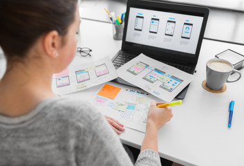 Wall Mural - app design, technology and business concept - web designer or developer with sketches and laptop com