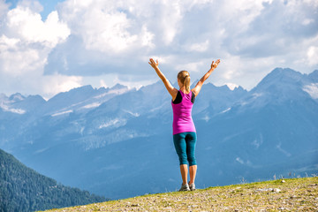 Wall Mural - young woman on the top of mountains