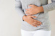 © Siam - Young woman having painful stomachache. Chronic gastritis. Abdomen bloating concept.