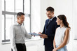 © Syda Productions - real estate business, sale and people concept - male realtor with clipboard and pen showing contract document to customers at new office room