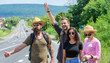 © be free - Friends hitchhikers travelling summer sunny day. Begin great adventure in your life with hitchhiking. Travellers try to stop car. Company friends travelers hitchhiking at edge road nature background