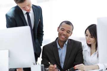 project Manager and business team discussing work documents