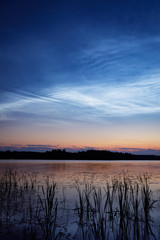 Wall Mural - night shining clouds over lake in finland