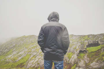 Man looking out from the top of a mountain