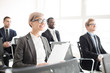 © pressmaster - Group of diverse men and woman with papers sitting in conference hall and listening to speech enjoying business seminar