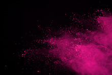 Abstract Pink Powder Explosion On Black Background. Abstract Colored Powder Splatted, Freeze Motion Of Pink Powder Exploding.