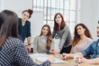 © contrastwerkstatt - Group of young businesswomen listening attentively