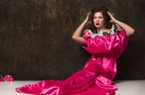 Fototapeta Dmuchawce - Portrait of an Elegant Woman in Pink Dress with Flowers