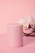 Delicate scented pink candle over the pastel pink background with copy space