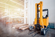 © Parilov - Warehouse industrial premises for storing materials and wood, there is forklift containers. Concept logistics, transport. Motion blur effect. Bright sunlight.