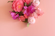Directly above view of pink and purple camellias and azaleas on pink background with copy space (selective focus)