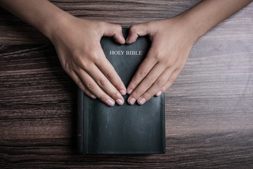 Holy Bible With Heart Shape Hands