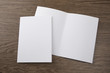 Mockup of white booklet on wooden background.