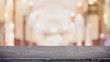 © bunditinay - Empty black marble stone table top on blurred with bokeh shopping mall background - can be used for display or montage your products