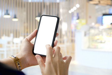 Cropped shot of an unrecognizable woman using mobile phone in cafe.