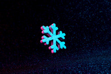 Snowflake In Vivid Neon Colors. Christmas Or Winter Dark Background  Concept.