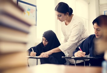 Wall Mural - Diverse Muslim girls studying in classroom