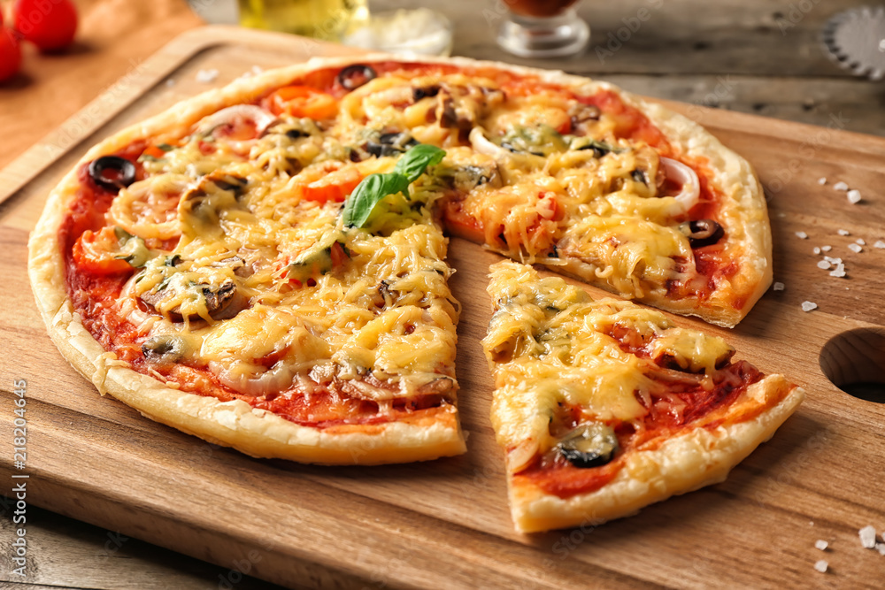 Tasty pizza on wooden board, closeup