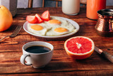 Fototapeta Kuchnia - Breakfast with coffee and fried eggs