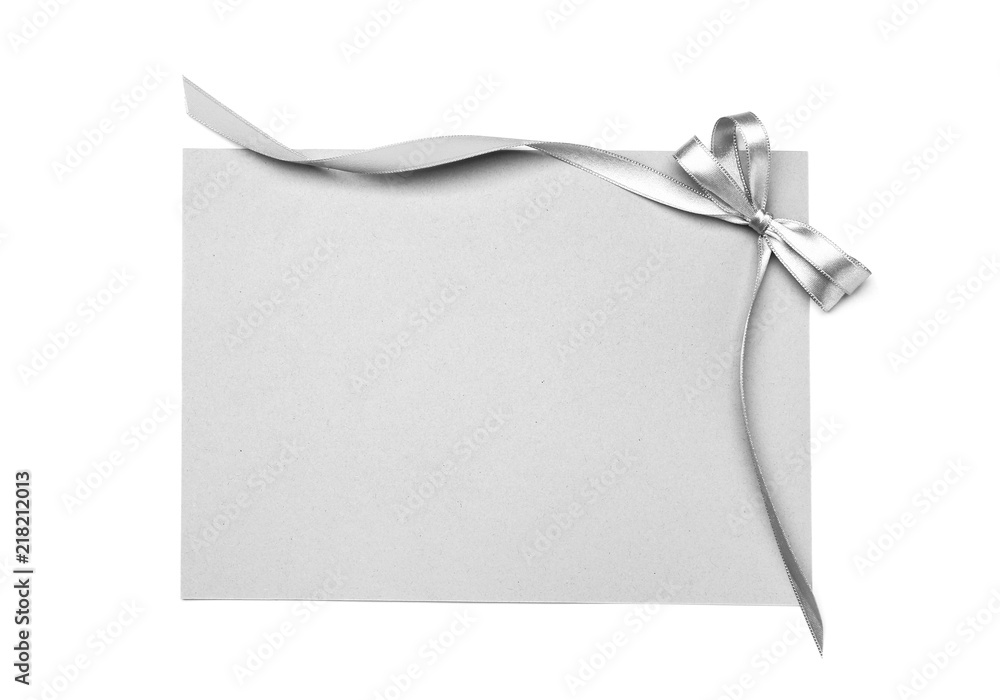 Blank paper card with silver ribbon and bow on white background