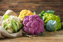Colorful Cauliflowers On Wooden Table